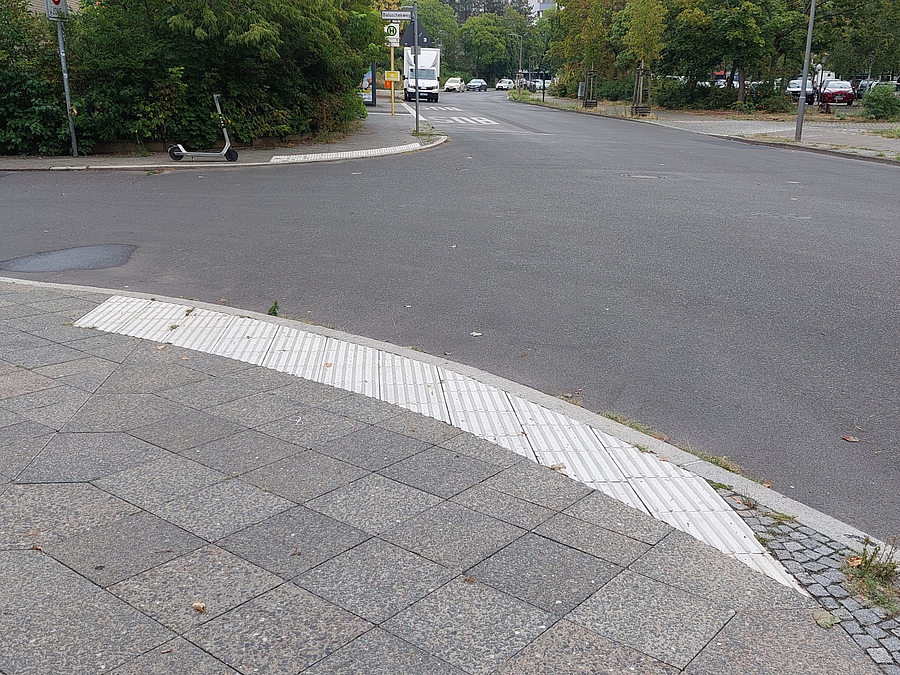 Einmündung mit Borsteinabsenkung und Markierung für Sehgeschädigte