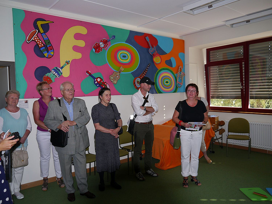 Gruppe unter farbigem Wandbild