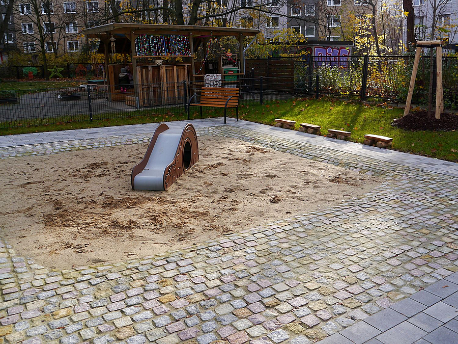 Winzige Rutsche auf Sandfläche