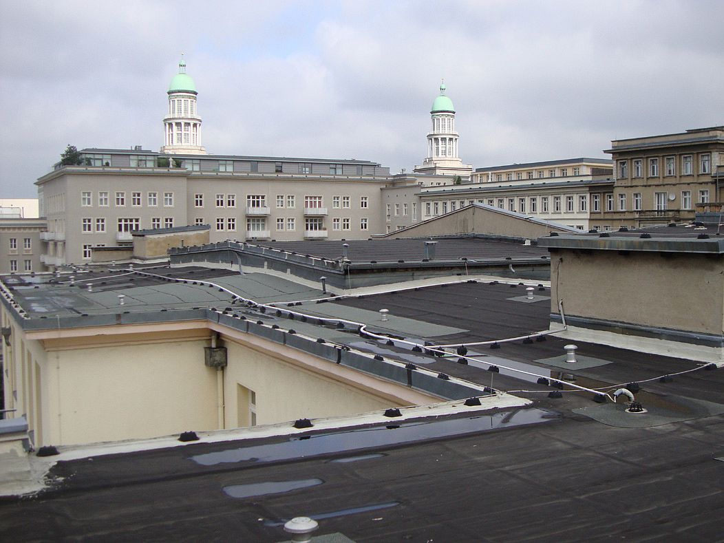 Blick über Dächer mit Teerpappe zu den Türmen am Frankfurter Tor